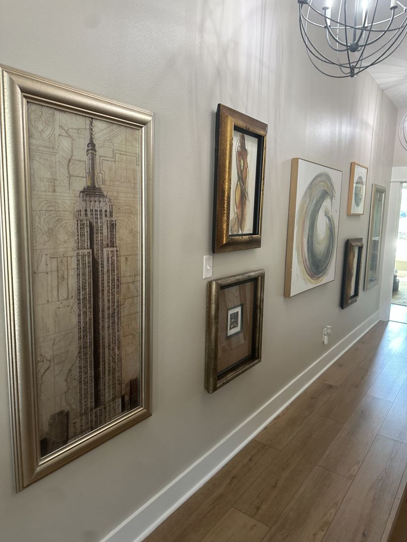 Framed art hung in a hallway