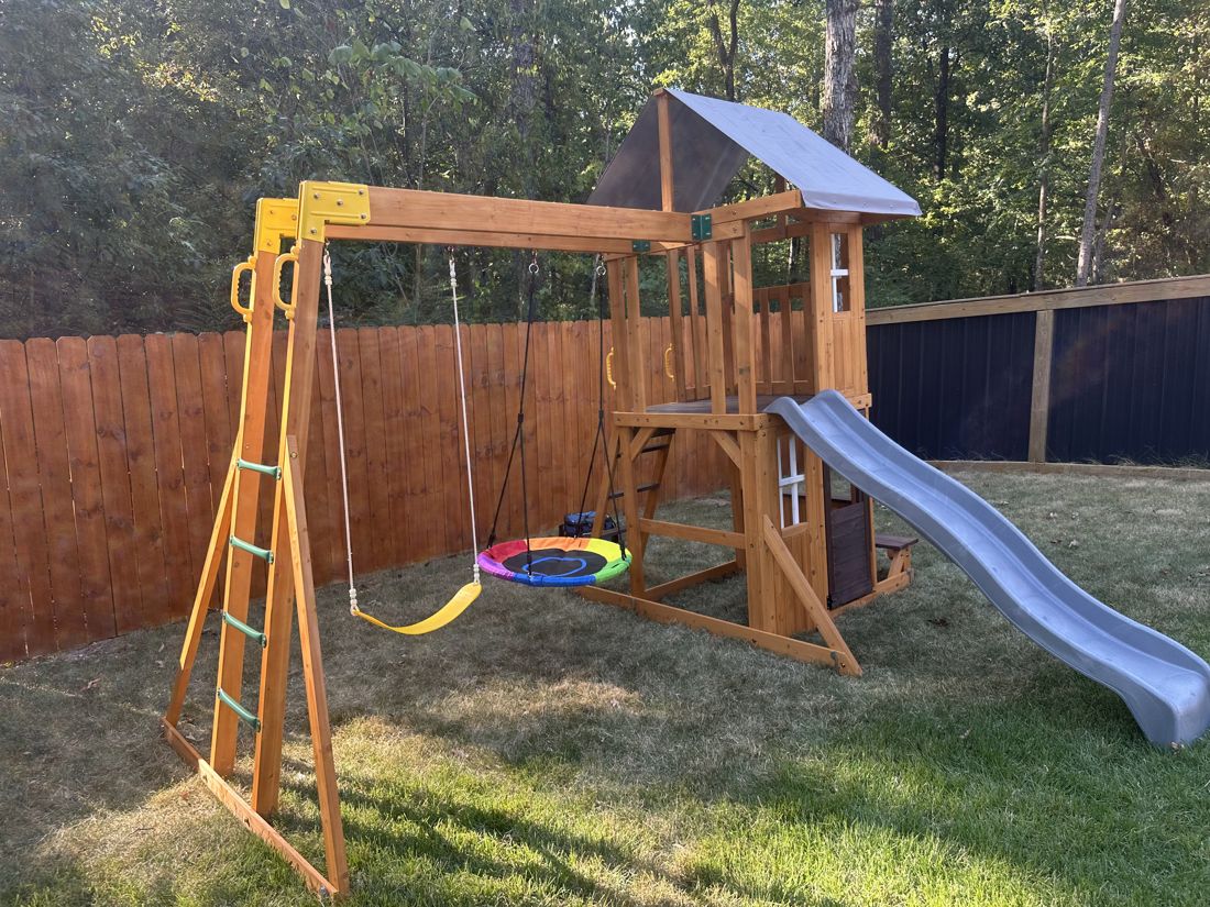 Assembled backyard playset with slide and swings
