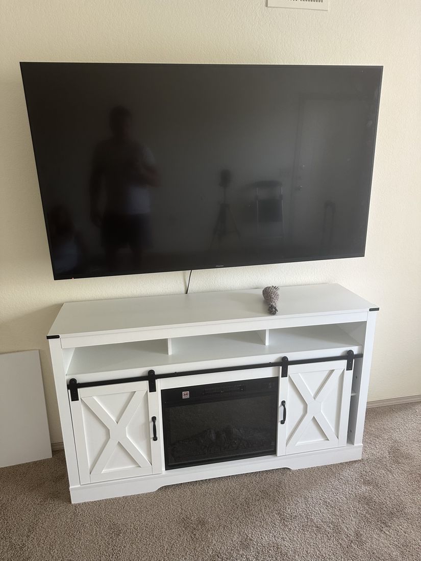 TV mounted on wall above media console